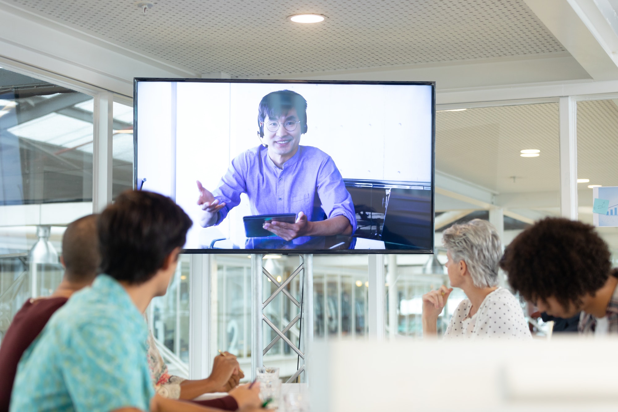 Diverse business people attending video conference at conference room