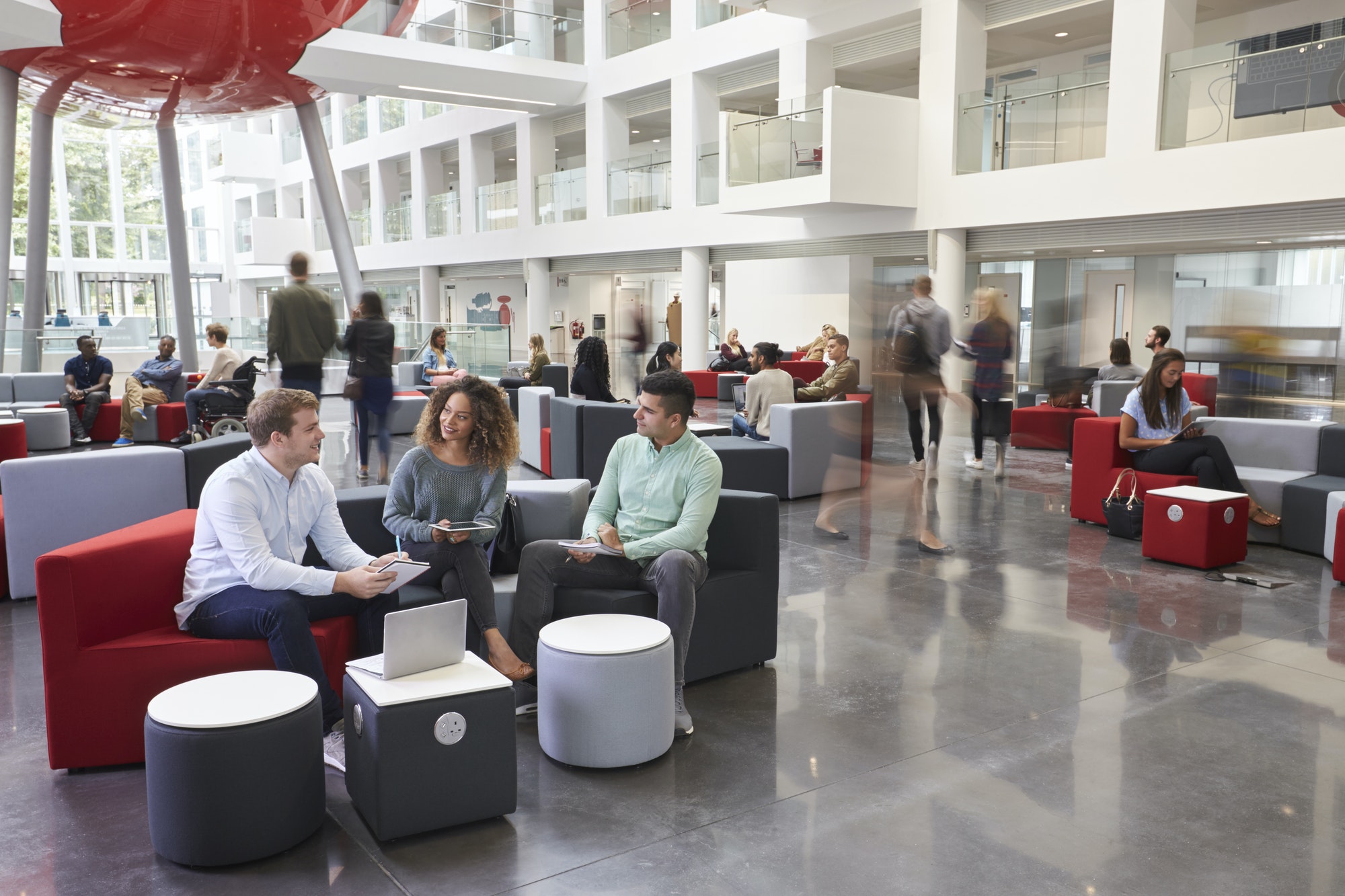 Students talking in busy university campus building