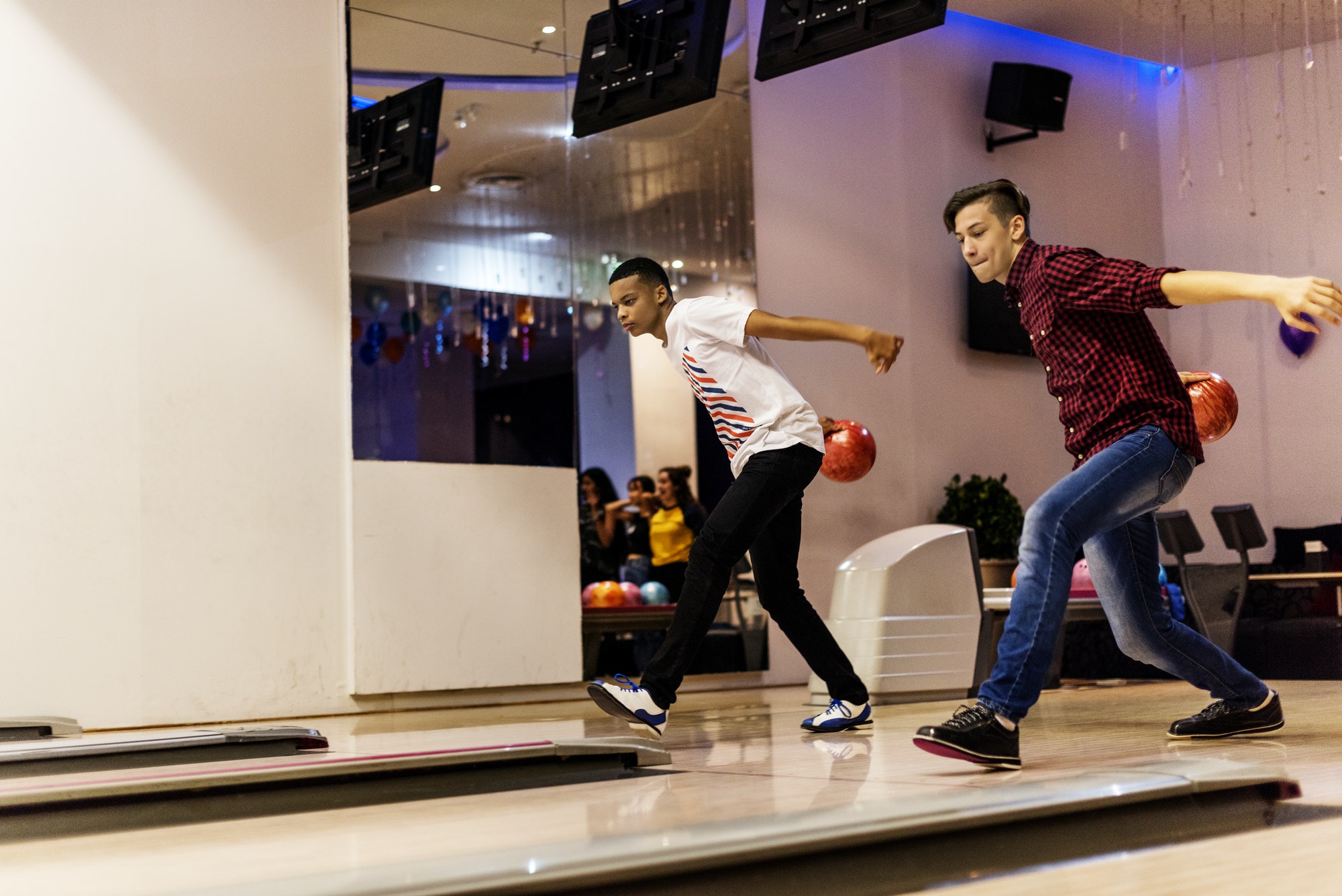 Teen boys bowling together