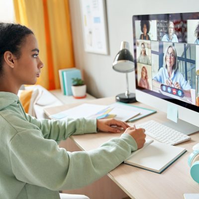 Mixed race teen school girl remote learning during online group class.