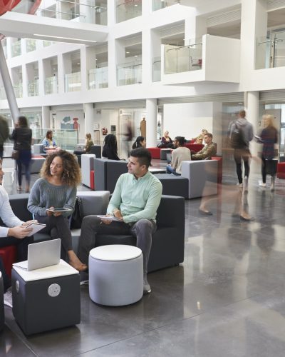 Students talking in busy university campus building