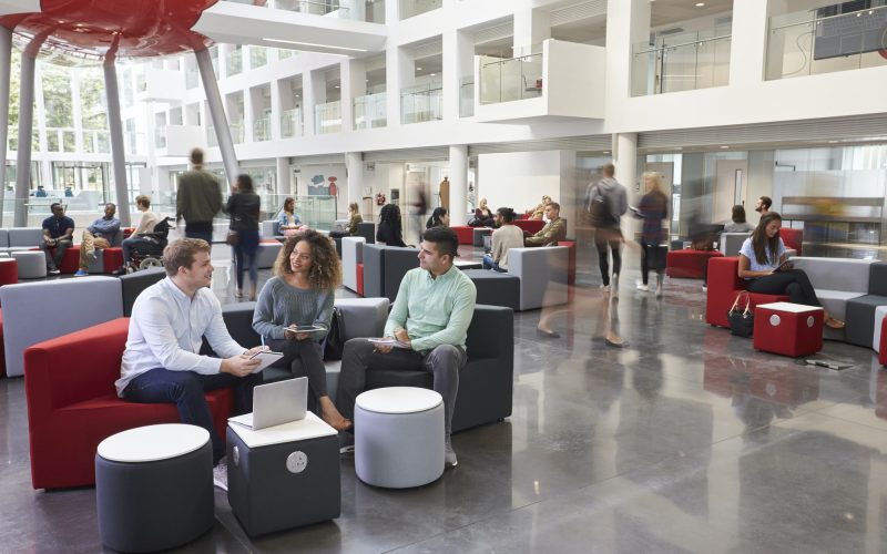 Students talking in busy university campus building