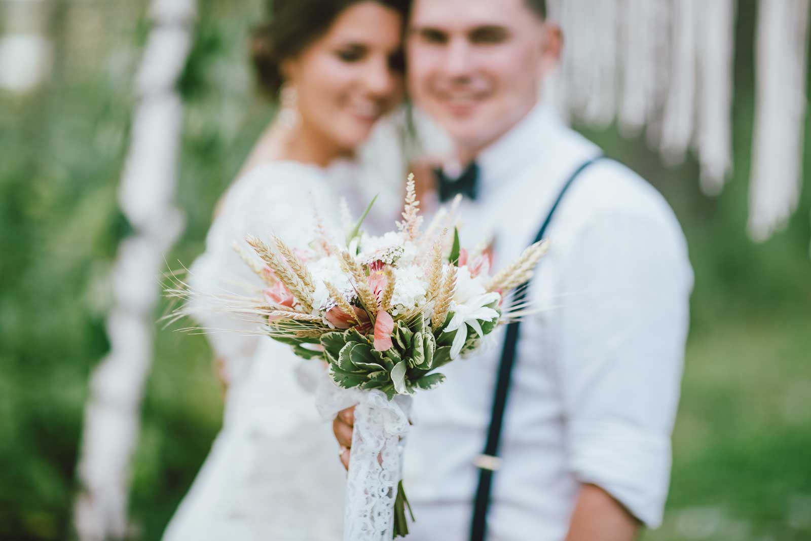 bg-header-1-happy-newly-married-couple-with-boho-style-bouquet-N26JKP7.jpg