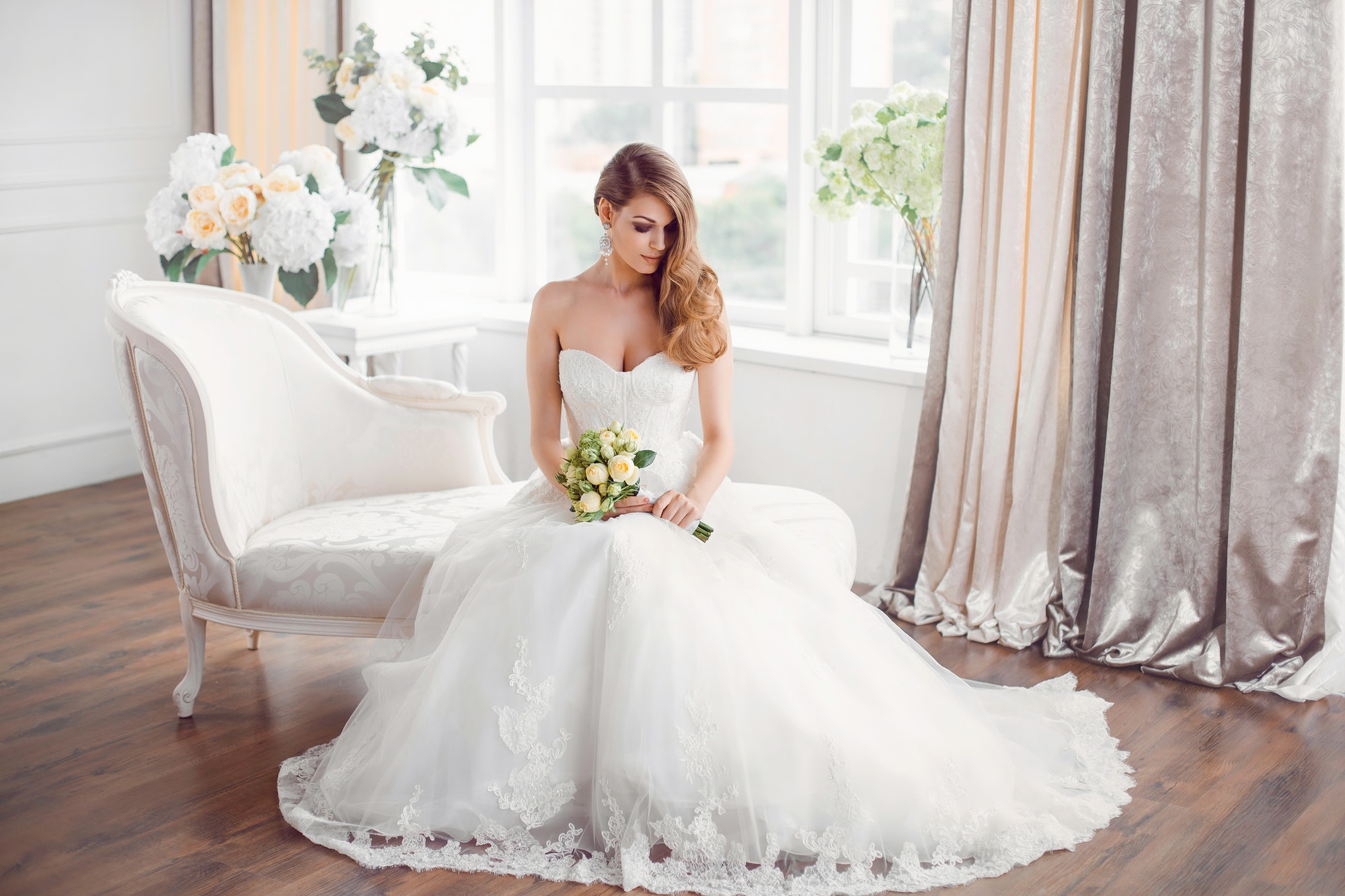 bride-in-beautiful-dress-sitting-resting-on-sofa-indoors.jpg