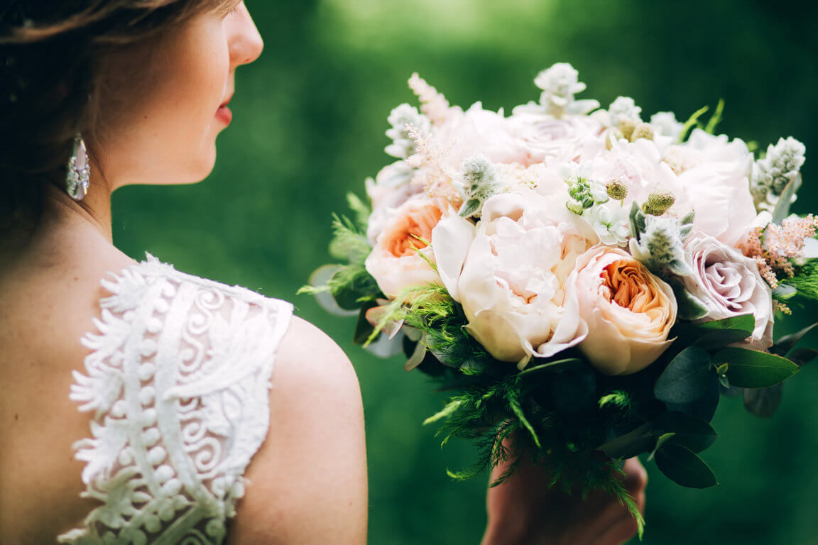 optimize- tender-bride-holding-wedding-bouquet-bride-nature-with-bouquet-peonies